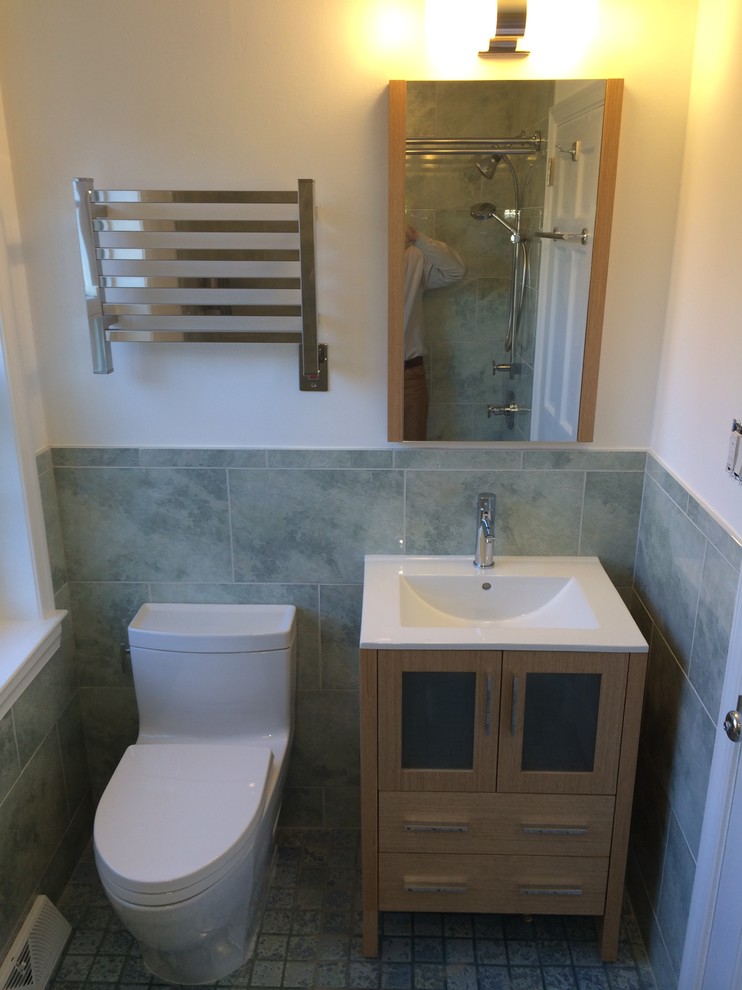 Inspiration for a small transitional master green tile and ceramic tile porcelain tile tub/shower combo remodel in Philadelphia with a drop-in sink, glass-front cabinets, light wood cabinets, a one-piece toilet and white walls