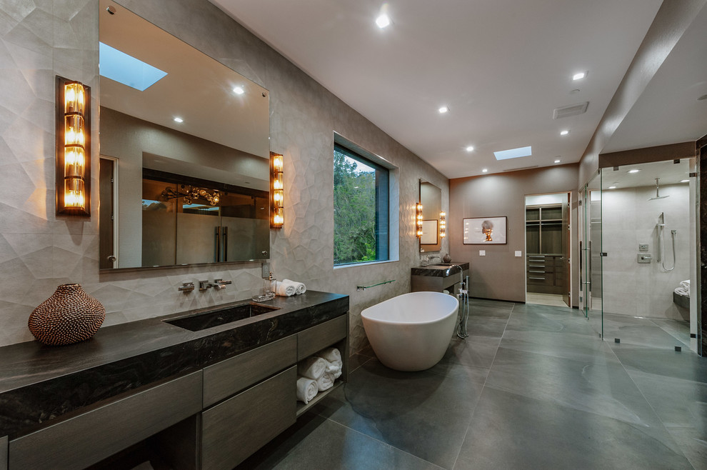 Bathroom - huge contemporary master gray floor bathroom idea in Los Angeles with flat-panel cabinets, gray cabinets, an integrated sink, marble countertops, a hinged shower door and black countertops