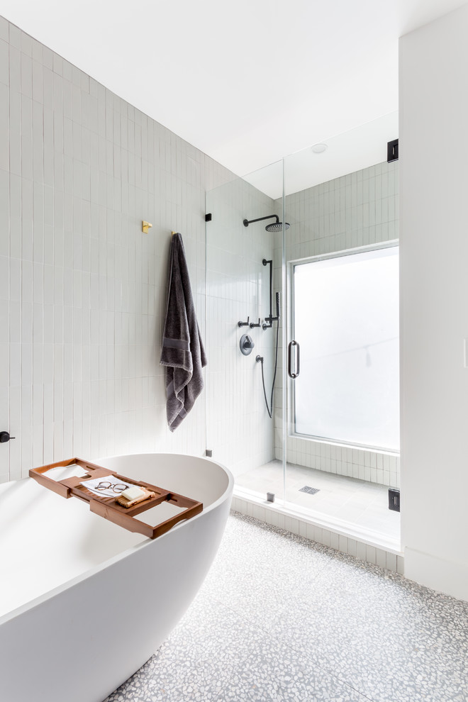 Свежая идея для дизайна: большая главная ванная комната в стиле ретро с плоскими фасадами, темными деревянными фасадами, отдельно стоящей ванной, душем в нише, унитазом-моноблоком, серой плиткой, керамической плиткой, белыми стенами, полом из терраццо, врезной раковиной, столешницей из искусственного кварца, серым полом, душем с распашными дверями и белой столешницей - отличное фото интерьера