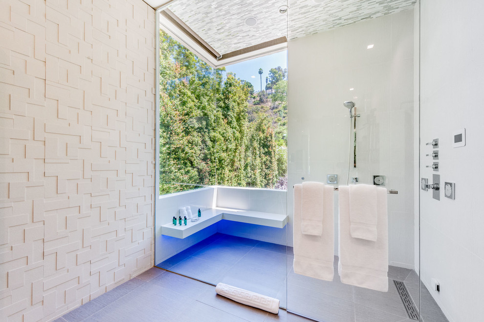 Design ideas for an expansive contemporary ensuite wet room bathroom in Los Angeles with a freestanding bath, white tiles, white walls, light hardwood flooring, an integrated sink, solid surface worktops and a hinged door.