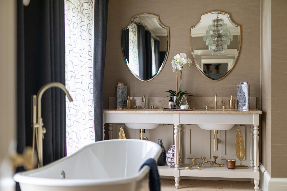 Inspiration for a medium sized classic ensuite bathroom in London with white cabinets, a freestanding bath, beige walls, light hardwood flooring, a submerged sink, beige floors, beige worktops and open cabinets.