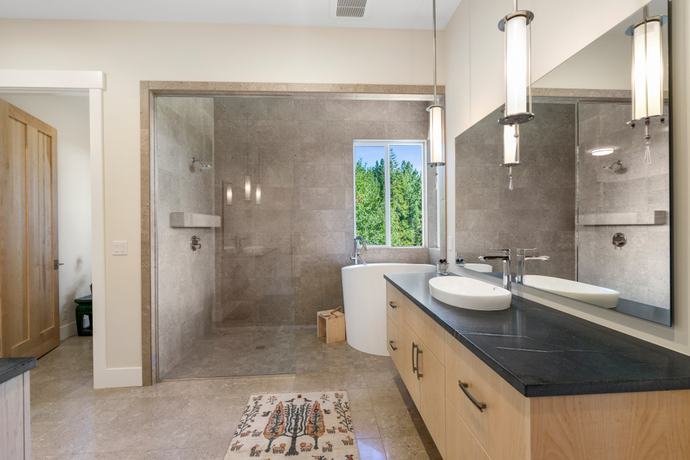 Inspiration for a contemporary ensuite wet room bathroom in Seattle with flat-panel cabinets, medium wood cabinets, a japanese bath, grey tiles, beige walls, a vessel sink, beige floors, an open shower, black worktops, an enclosed toilet, a single sink and a floating vanity unit.