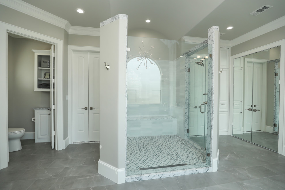 Example of a huge transitional master bathroom design in Houston with raised-panel cabinets, white cabinets, a vessel sink and marble countertops