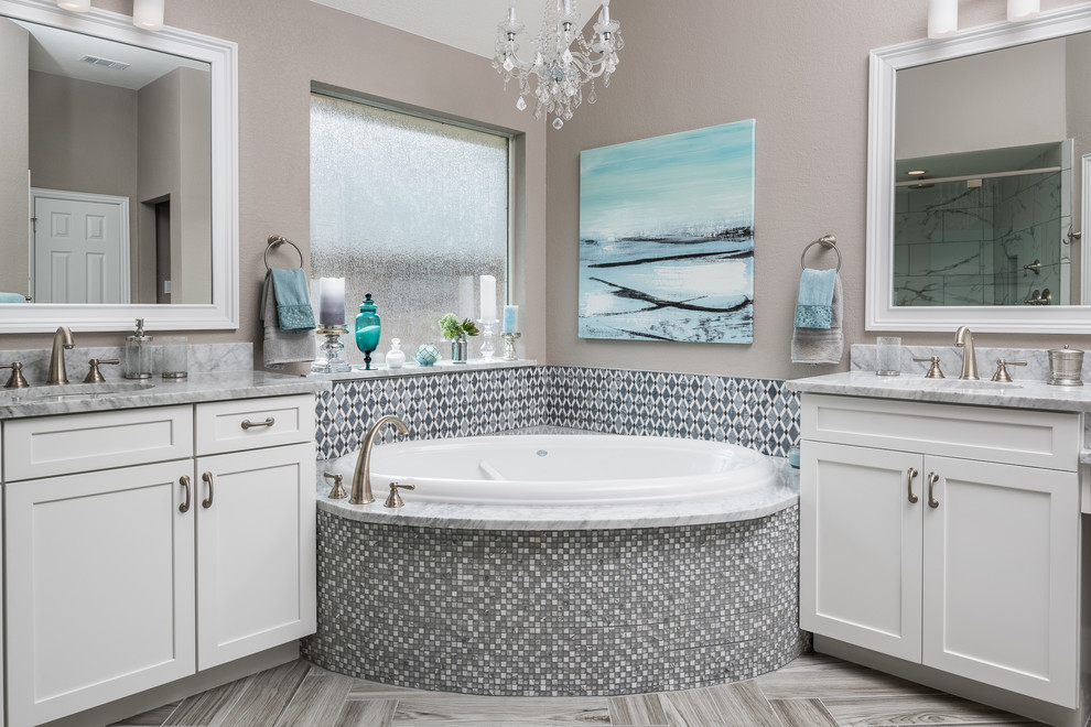 Bathroom - large modern multicolored tile and mosaic tile light wood floor and gray floor bathroom idea in Dallas with recessed-panel cabinets, white cabinets, a one-piece toilet, gray walls, an undermount sink, marble countertops and a hinged shower door