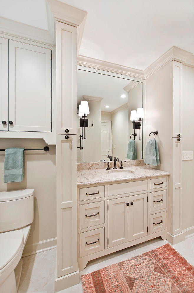Example of a mid-sized classic master white tile and porcelain tile porcelain tile and white floor alcove shower design in Nashville with recessed-panel cabinets, white cabinets, a two-piece toilet, white walls, an undermount sink, quartz countertops, a hinged shower door and multicolored countertops