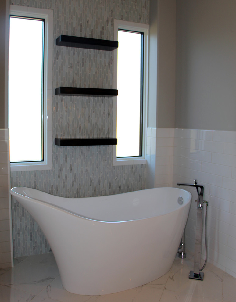 Medium sized contemporary ensuite bathroom in Wichita with dark wood cabinets, a freestanding bath, a pedestal sink and granite worktops.