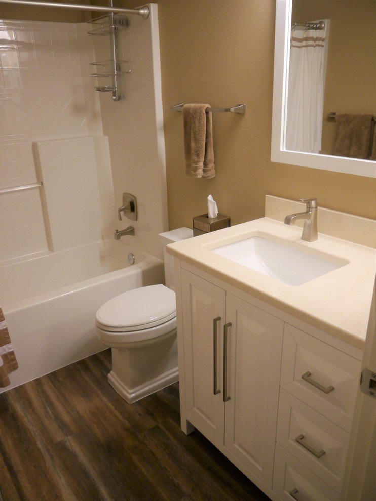 Bathroom - small transitional kids' white tile vinyl floor and brown floor bathroom idea in Seattle with raised-panel cabinets, white cabinets, a two-piece toilet, beige walls, an undermount sink, quartz countertops and beige countertops