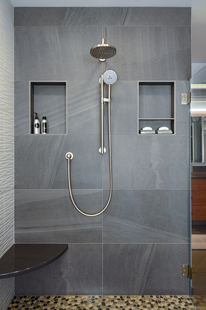 Inspiration for a large contemporary ensuite bathroom in Seattle with flat-panel cabinets, medium wood cabinets, a freestanding bath, a walk-in shower, a two-piece toilet, grey tiles, ceramic tiles, blue walls, pebble tile flooring, a submerged sink, engineered stone worktops, multi-coloured floors and an open shower.