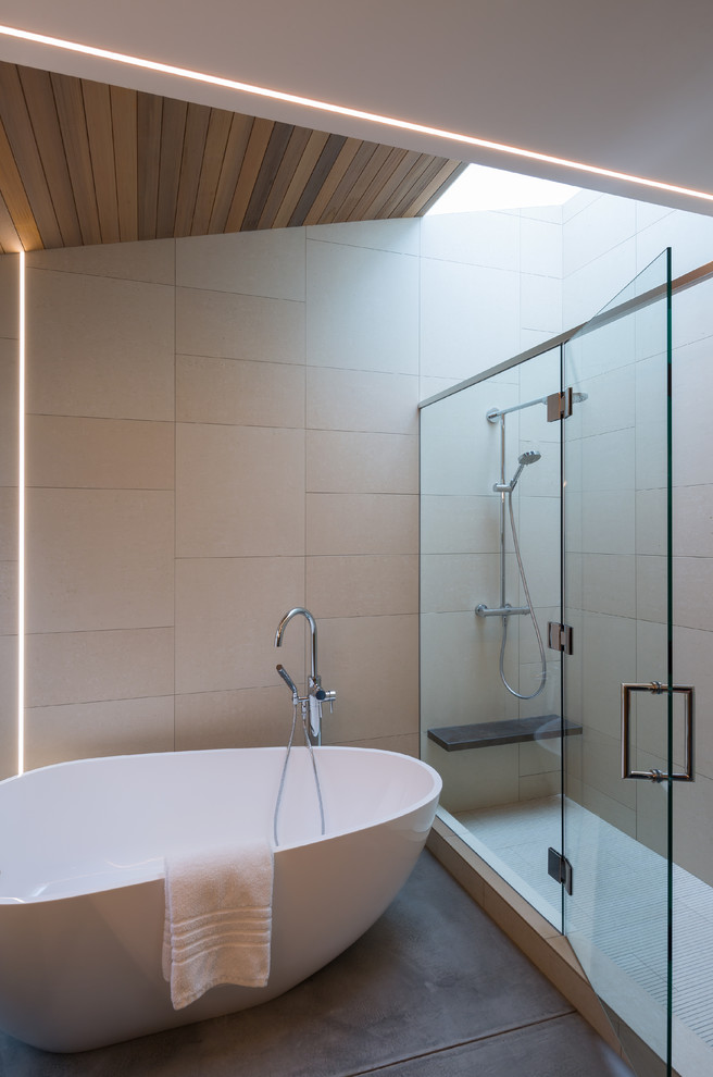 Example of a large 1950s master white tile and porcelain tile concrete floor bathroom design in Seattle with flat-panel cabinets, light wood cabinets, a one-piece toilet, white walls, an undermount sink and solid surface countertops