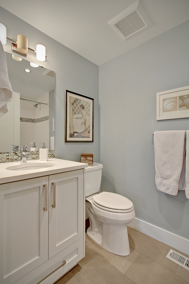 Mid-sized arts and crafts 3/4 multicolored tile and mosaic tile porcelain tile bathroom photo in Seattle with an undermount sink, recessed-panel cabinets, white cabinets, quartz countertops, a two-piece toilet and gray walls