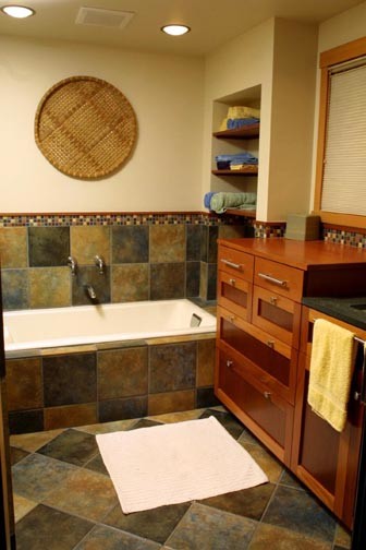 Photo of a classic family bathroom in Seattle with shaker cabinets, dark wood cabinets, granite worktops, stone tiles, an alcove bath, green tiles and yellow walls.