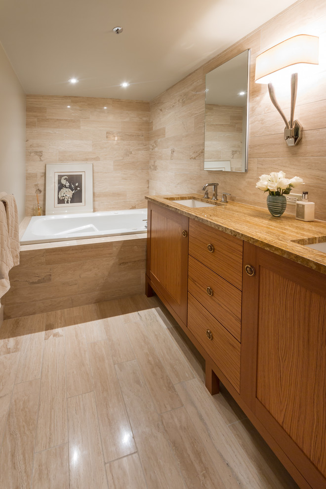 Bild på ett mellanstort funkis badrum, med ett undermonterad handfat, luckor med infälld panel, skåp i mellenmörkt trä, granitbänkskiva, ett platsbyggt badkar, en dusch i en alkov, stenkakel och kalkstensgolv
