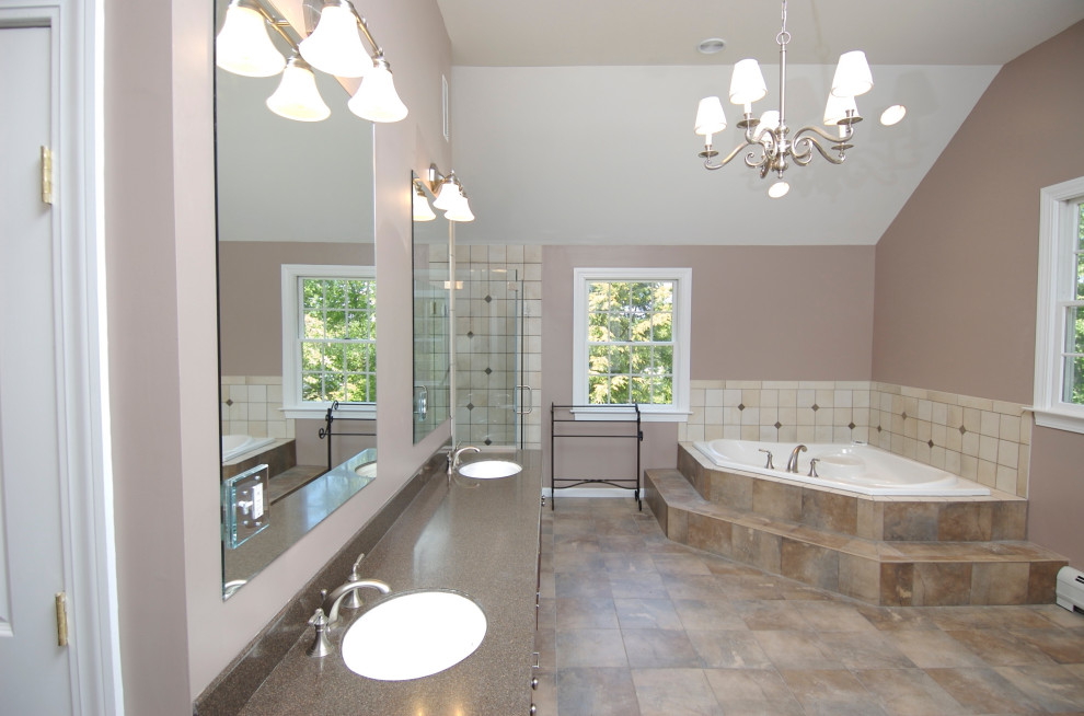 Example of a large country master brown tile and ceramic tile ceramic tile and brown floor bathroom design in Denver with raised-panel cabinets, a one-piece toilet, beige walls, an undermount sink, solid surface countertops, a hinged shower door and brown countertops