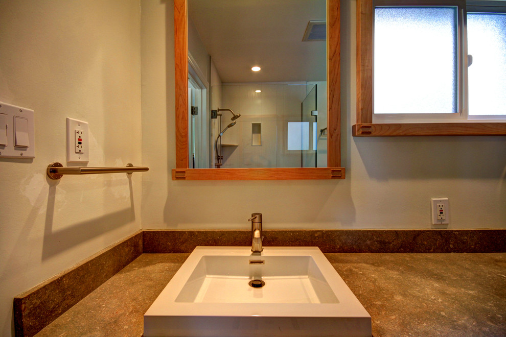 Example of a bathroom design in San Francisco with solid surface countertops, white walls and a vessel sink