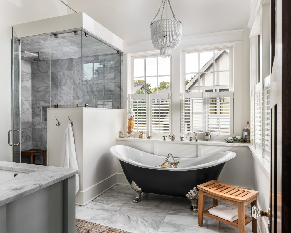 This is an example of a medium sized traditional ensuite bathroom in Nashville with shaker cabinets, grey cabinets, a corner shower, grey tiles, grey walls, a hinged door, a claw-foot bath, a submerged sink, grey floors and white worktops.