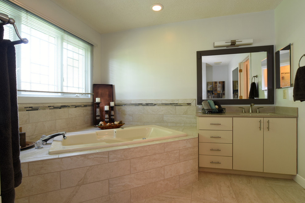 Photo of a classic ensuite bathroom in Other with flat-panel cabinets, white cabinets, a hot tub, beige tiles, porcelain tiles, white walls, porcelain flooring, a submerged sink and beige floors.