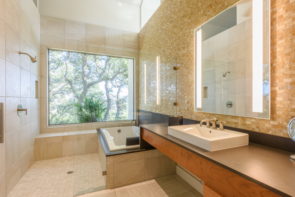 Modernes Badezimmer mit hellen Holzschränken, Einbaubadewanne, offener Dusche, beigen Fliesen, Mosaikfliesen, Schieferboden, Aufsatzwaschbecken und Mineralwerkstoff-Waschtisch in Austin
