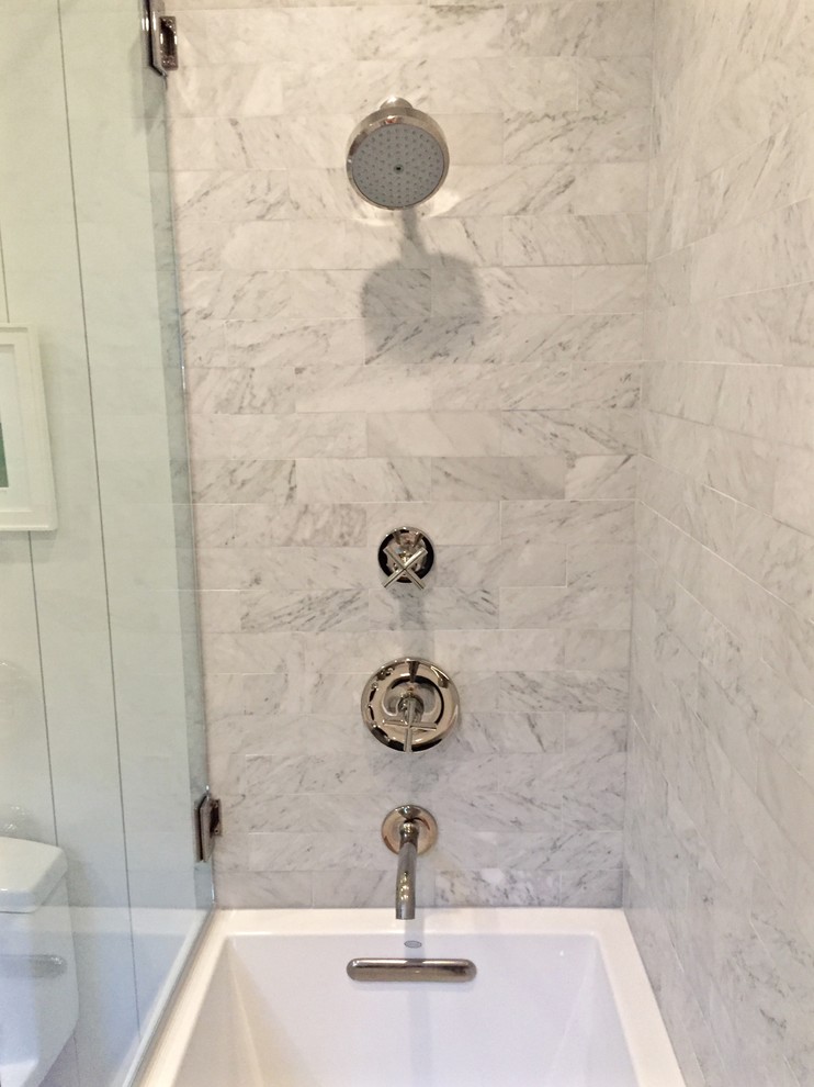 Photo of a small beach style ensuite bathroom in Los Angeles with flat-panel cabinets, white cabinets, an alcove bath, an alcove shower, a one-piece toilet, black and white tiles, marble tiles, white walls, porcelain flooring, a submerged sink, marble worktops, brown floors, an open shower and white worktops.