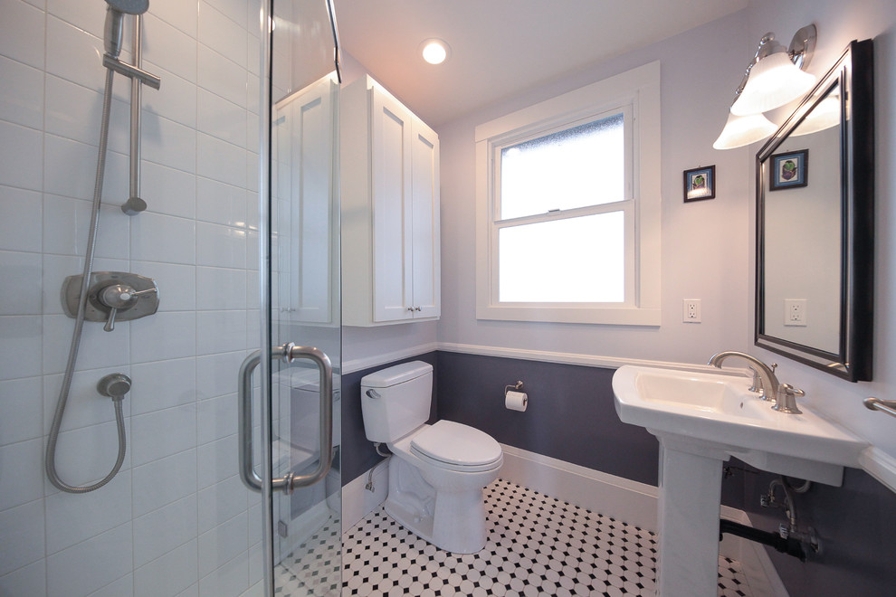 Klassisk inredning av ett mellanstort badrum för barn, med luckor med infälld panel, vita skåp, vit kakel, grå väggar, en hörndusch, en toalettstol med separat cisternkåpa, linoleumgolv och ett piedestal handfat