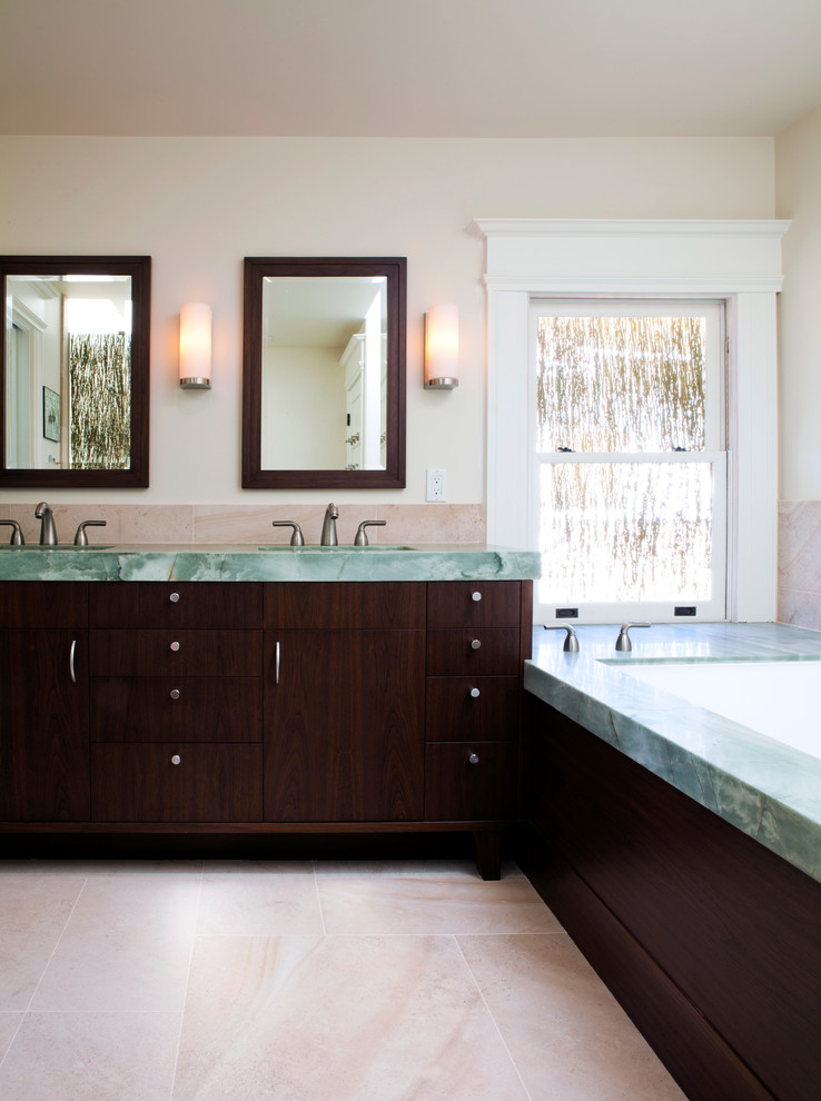 Inspiration for a large contemporary ensuite bathroom in San Francisco with a submerged sink, freestanding cabinets, dark wood cabinets, marble worktops, a submerged bath, beige tiles, stone tiles, beige walls, porcelain flooring and beige floors.
