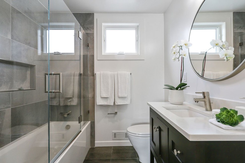 Inspiration för ett litet funkis vit vitt badrum med dusch, med skåp i shakerstil, svarta skåp, bänkskiva i kvarts, skiffergolv, ett badkar i en alkov, en dusch/badkar-kombination, en toalettstol med hel cisternkåpa, grå kakel, skifferkakel, grå väggar, ett undermonterad handfat, svart golv och dusch med gångjärnsdörr