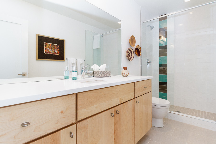 Design ideas for a medium sized modern bathroom in Denver with flat-panel cabinets, light wood cabinets, white tiles, white walls, ceramic flooring and a submerged sink.