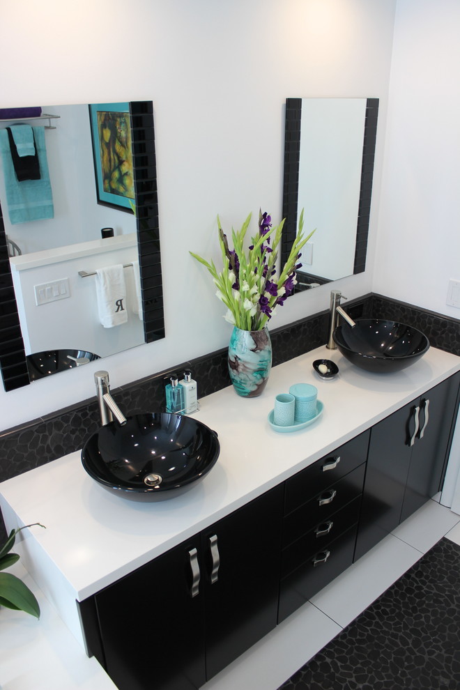 This is an example of a medium sized contemporary ensuite bathroom in Los Angeles with flat-panel cabinets, black cabinets, white walls, a vessel sink, quartz worktops and white floors.