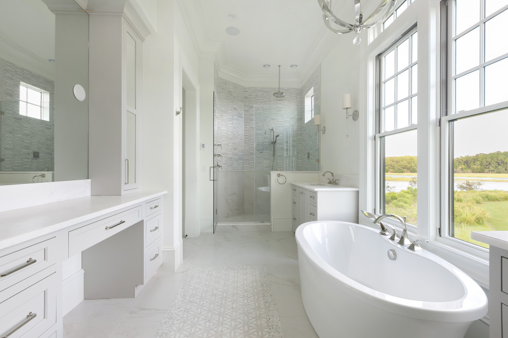 На фото: главная ванная комната в морском стиле с фасадами в стиле шейкер, серыми фасадами, отдельно стоящей ванной, душем в нише, белыми стенами, врезной раковиной, белым полом, душем с распашными дверями и белой столешницей с