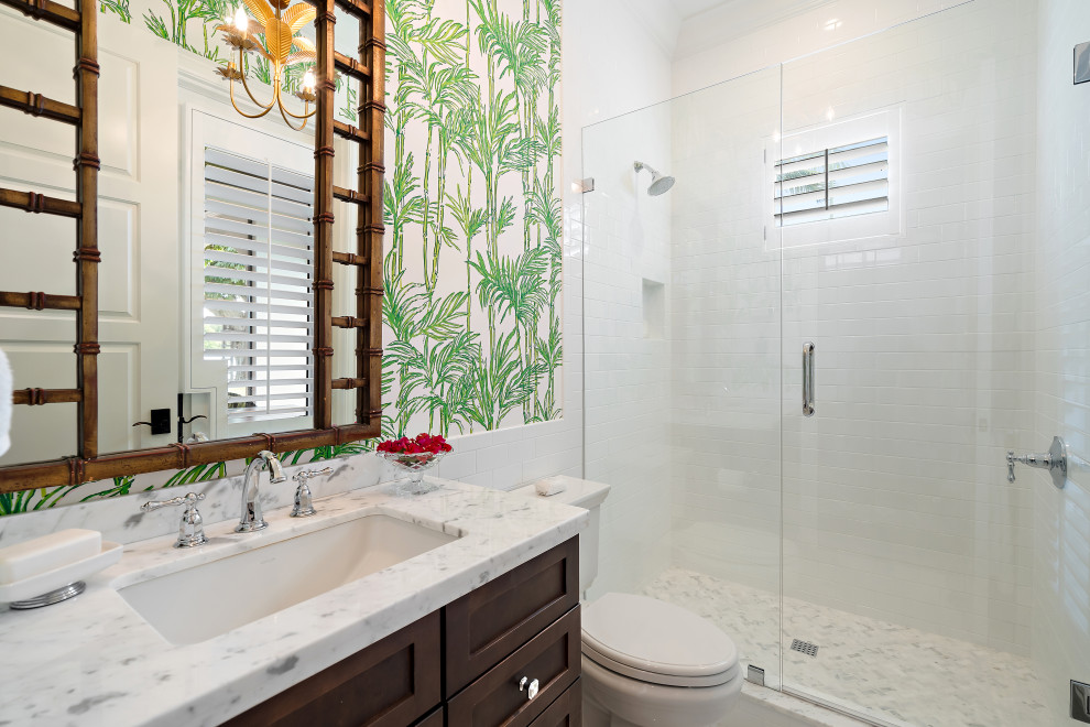 Alcove shower - mid-sized transitional 3/4 white tile and porcelain tile single-sink alcove shower idea in Miami with shaker cabinets, medium tone wood cabinets, multicolored walls, an undermount sink, a hinged shower door, multicolored countertops and a built-in vanity