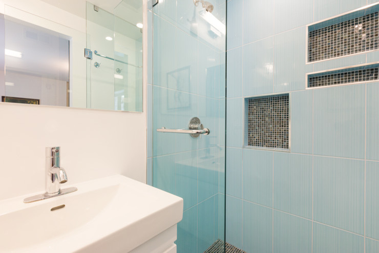 Cette photo montre une petite salle de bain tendance avec un placard à porte plane, des portes de placard blanches, WC séparés, un carrelage bleu, des carreaux de céramique, un mur blanc, un sol en carrelage de céramique, un lavabo posé et un plan de toilette en surface solide.