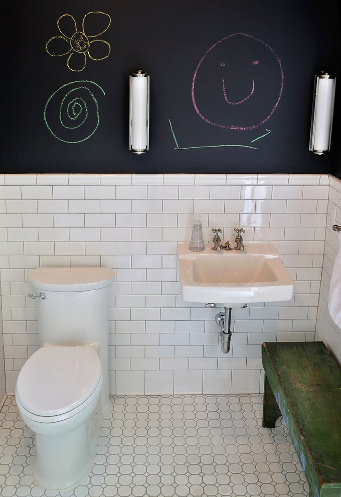 Photo of a small rustic shower room bathroom in New York with a wall-mounted sink, a one-piece toilet, white tiles, metro tiles, black walls and mosaic tile flooring.