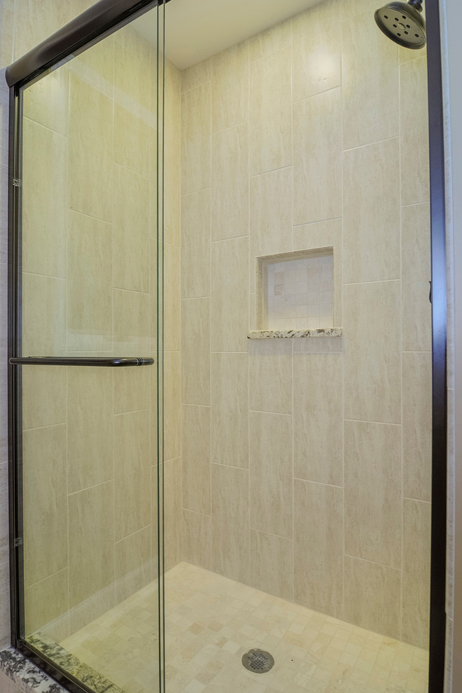Inspiration for a timeless beige tile and porcelain tile corner shower remodel in Chicago with an undermount sink, raised-panel cabinets, brown cabinets, granite countertops and a two-piece toilet