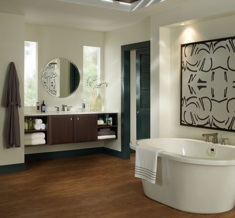 Design ideas for a large contemporary ensuite bathroom in Other with flat-panel cabinets, dark wood cabinets, a freestanding bath, white walls, medium hardwood flooring, a submerged sink, quartz worktops and brown floors.
