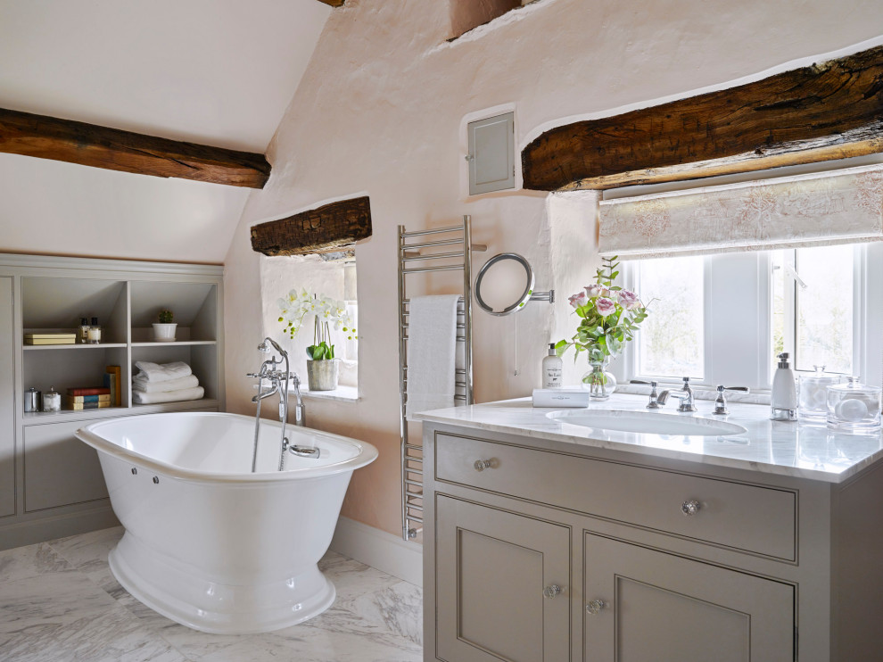 Inspiration for a large traditional family bathroom in Other with beaded cabinets, grey cabinets, a freestanding bath, a built-in sink, marble worktops, white worktops, a single sink, a built in vanity unit and exposed beams.