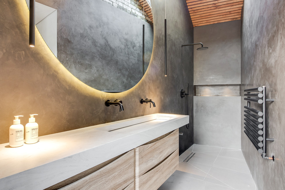 Foto på ett funkis vit badrum, med skåp i ljust trä, en kantlös dusch, gröna väggar, ett avlångt handfat, grått golv, med dusch som är öppen och släta luckor