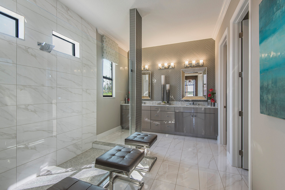 This is an example of a contemporary ensuite bathroom in Orlando with flat-panel cabinets, grey cabinets, a corner shower, grey tiles, glass tiles, white walls, a submerged sink, white floors, an open shower, white worktops, double sinks and a built in vanity unit.