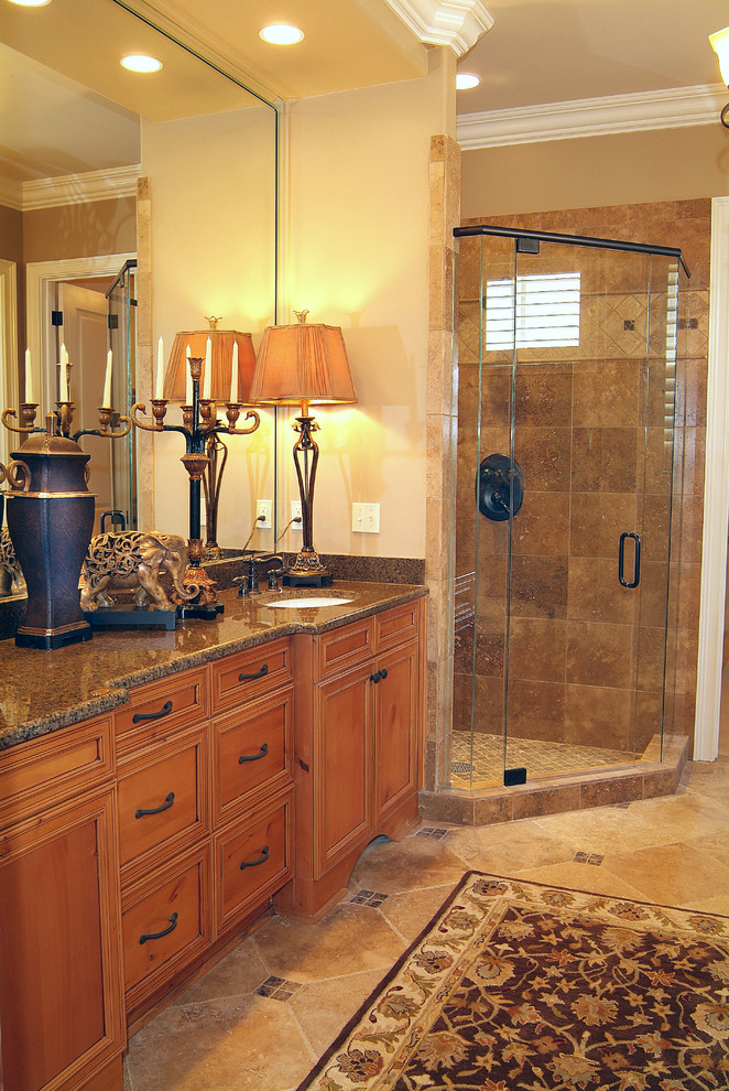 Inspiration for a large timeless master beige tile, brown tile and ceramic tile ceramic tile and beige floor bathroom remodel in Nashville with recessed-panel cabinets, medium tone wood cabinets, beige walls, an undermount sink, granite countertops and a hinged shower door