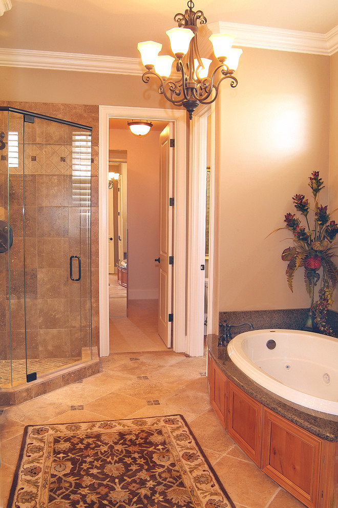 Large elegant master beige tile, brown tile and ceramic tile ceramic tile and beige floor bathroom photo in Nashville with beige walls, a hinged shower door, an undermount sink, granite countertops, recessed-panel cabinets and medium tone wood cabinets
