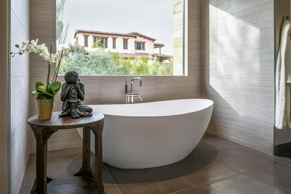 Foto di una grande stanza da bagno padronale design con vasca freestanding, piastrelle grigie e pavimento grigio