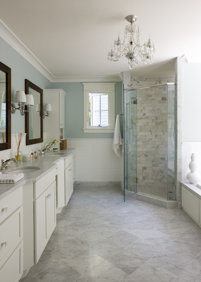 Elegant white tile gray floor corner shower photo in DC Metro with an undermount sink, recessed-panel cabinets, white cabinets, blue walls and gray countertops