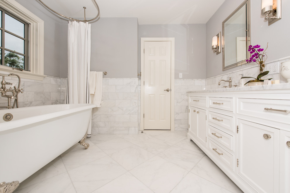 Inspiration for a large eclectic master gray tile and stone tile marble floor bathroom remodel in DC Metro with recessed-panel cabinets, white cabinets, blue walls, granite countertops and an undermount sink