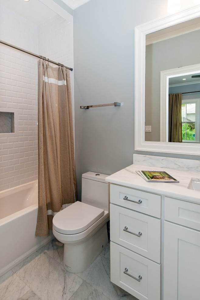 Example of a mid-sized trendy 3/4 beige tile and ceramic tile marble floor bathroom design in DC Metro with an undermount sink, recessed-panel cabinets, gray cabinets, granite countertops, a one-piece toilet and blue walls