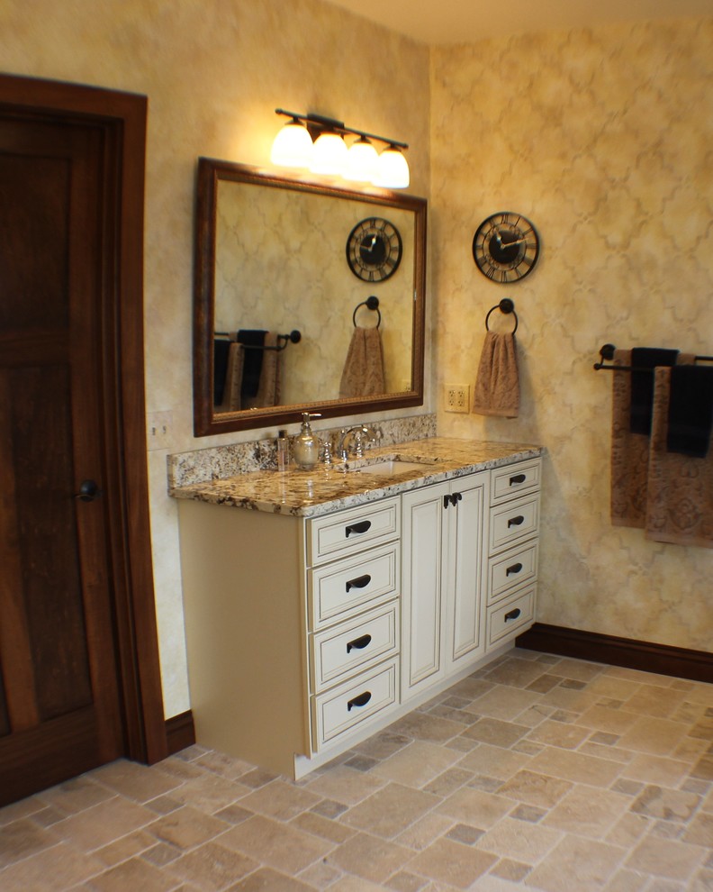 Inspiration for a mid-sized timeless master beige tile and ceramic tile ceramic tile corner shower remodel in Chicago with an undermount sink, raised-panel cabinets, dark wood cabinets, granite countertops and beige walls