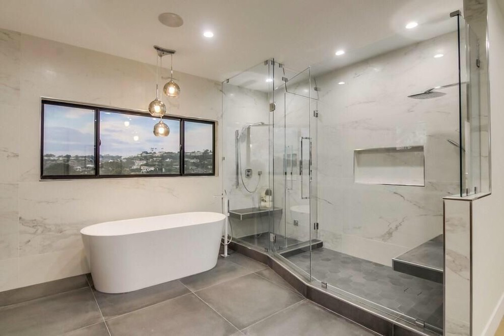 Inspiration for a large modern master white tile and ceramic tile ceramic tile and gray floor walk-in shower remodel in Los Angeles with flat-panel cabinets, medium tone wood cabinets, a one-piece toilet, white walls, a drop-in sink, quartz countertops, a hinged shower door and white countertops