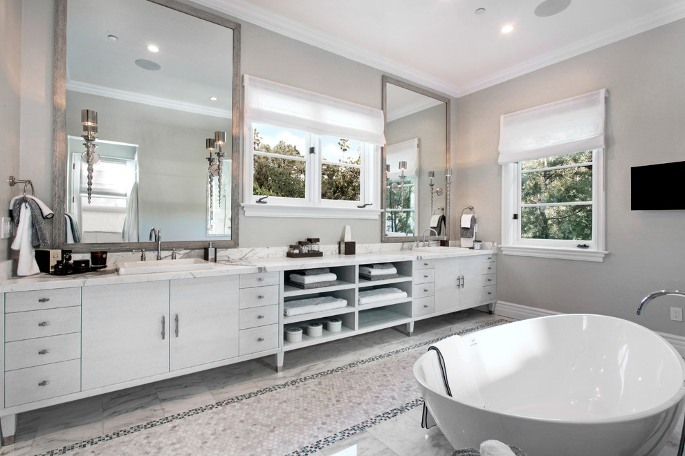 Bathroom - large transitional master gray tile and mosaic tile marble floor bathroom idea in Los Angeles with an integrated sink, furniture-like cabinets, light wood cabinets, marble countertops, a one-piece toilet and gray walls
