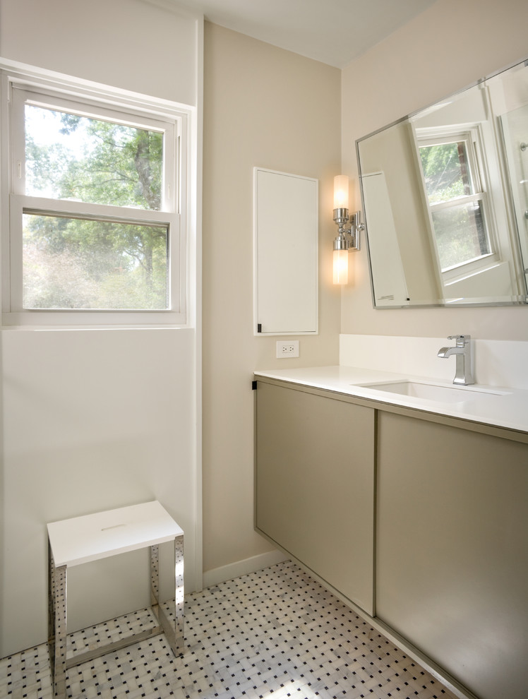 Idee per una stanza da bagno minimal con lavabo sottopiano, ante lisce, ante grigie, pareti beige e pavimento con piastrelle a mosaico