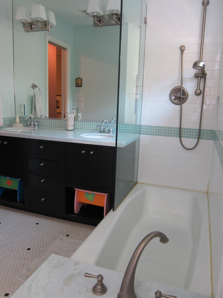 This is an example of a medium sized contemporary family bathroom in Houston with flat-panel cabinets, black cabinets, an alcove bath, a shower/bath combination, metro tiles, white walls, ceramic flooring, a submerged sink, quartz worktops, white floors and an open shower.