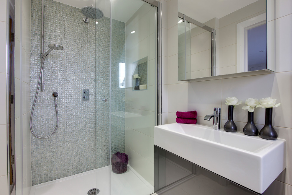 Inspiration for a small contemporary 3/4 mosaic tile porcelain tile walk-in shower remodel in Hertfordshire with flat-panel cabinets, gray cabinets, white walls and a wall-mount sink