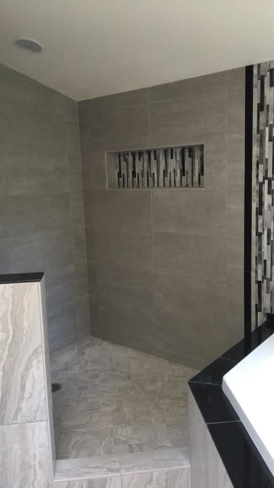 Example of a large trendy master black and white tile and mosaic tile porcelain tile bathroom design in Seattle with shaker cabinets, white cabinets, a two-piece toilet, beige walls, an undermount sink and granite countertops