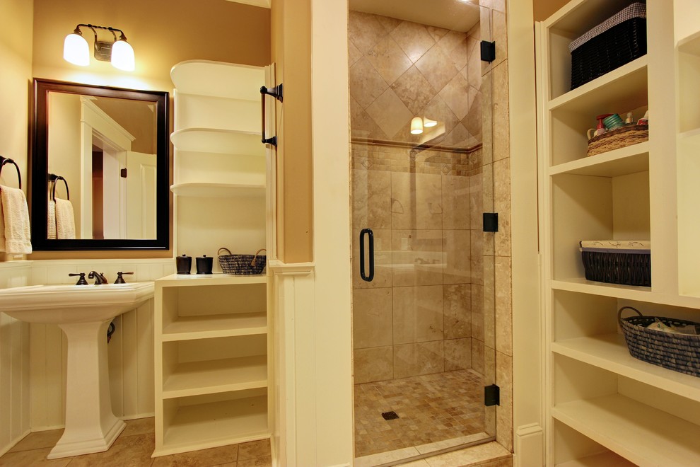Design ideas for an expansive classic shower room bathroom in Atlanta with a pedestal sink, open cabinets, white cabinets, a corner shower, a one-piece toilet, beige tiles, stone tiles, multi-coloured walls and travertine flooring.